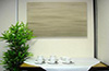 Artsorption sound absorbing painted panel on wall with green plant on table
