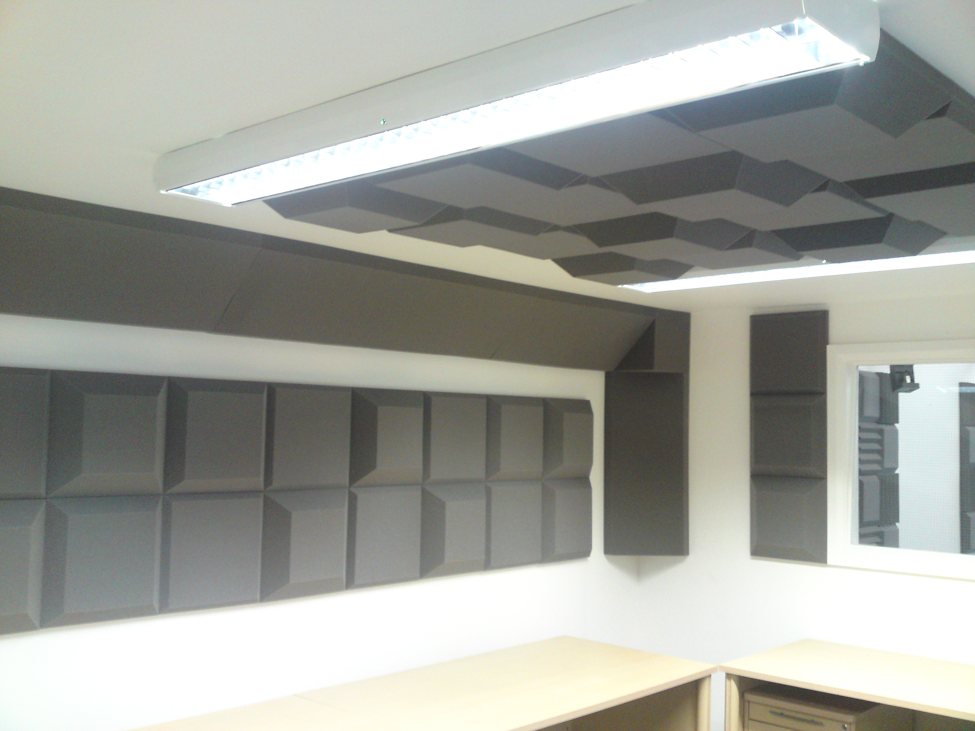 Mixed and matched Tegular sound absorbing tiles installed onto wall and ceiling of studio