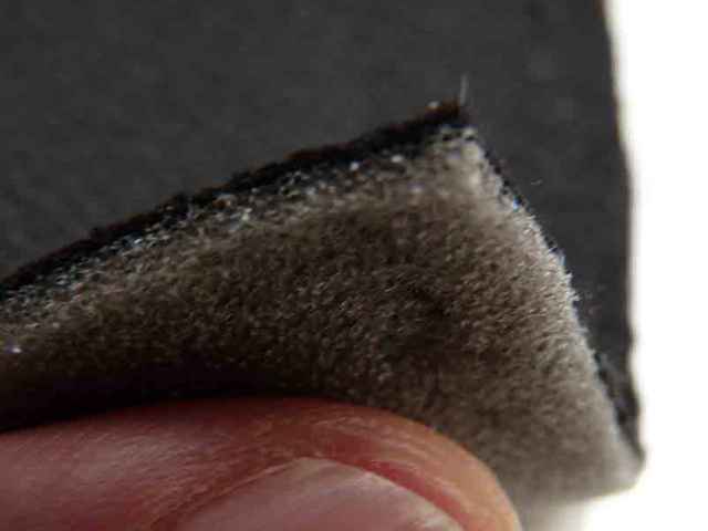 Sound absorbing foam backed acoustic fabric with thumb