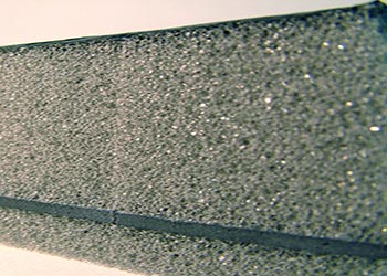 side view of soundproofing foam with sound barrier sandwiched within