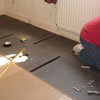 man installing QuietFloor acoustic underlay soundproofing onto a floor